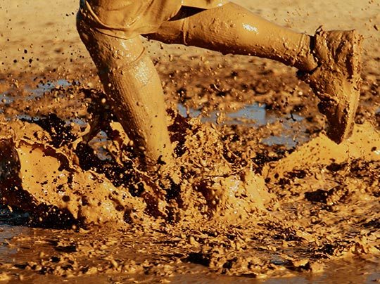 Man running through mud.