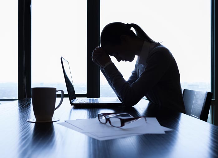 Stressed woman with laptop. Image © kieferpix / Adobe Stock