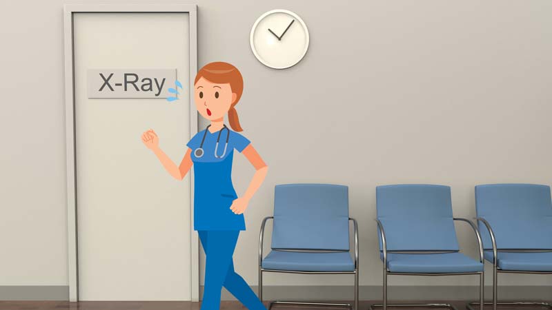 Nurse running in practice corridoor next to x-ray sign.